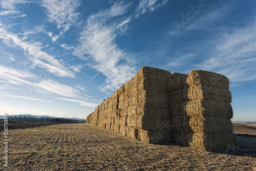 Large stack of hay bales.
