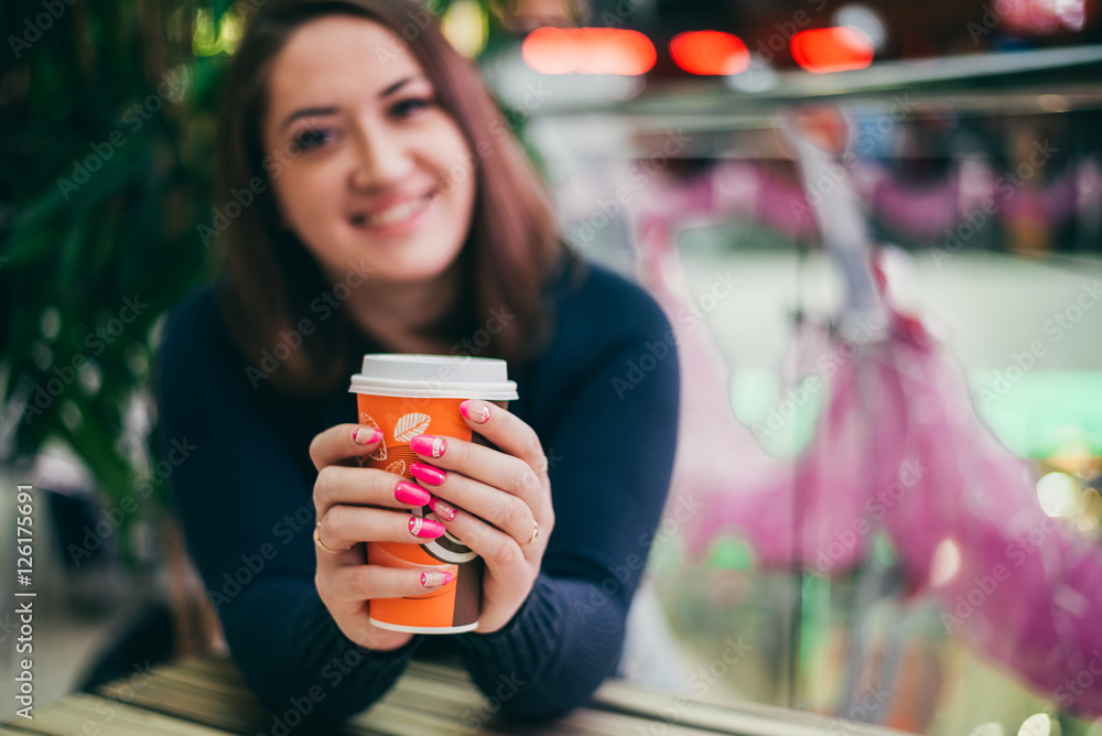 Smiling Girl holding a Cup of coffee. Manicure in pink colors Smiling Girl holding a Cup of coffee. Manicure in pink colors