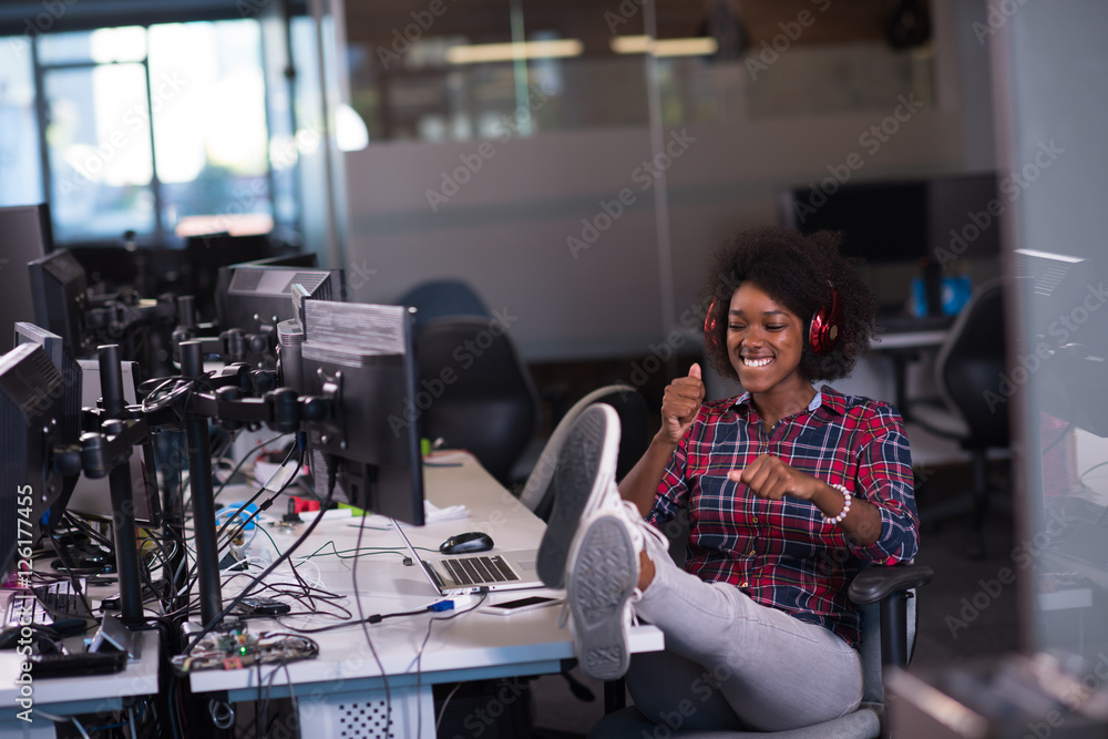 woman at her workplace in startup business office listening musi woman at her workplace in startup business office listening musi