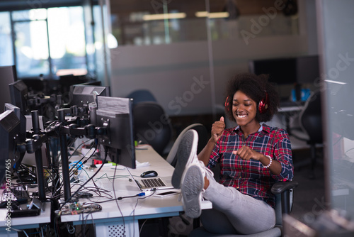 woman at her workplace in startup business office listening musi