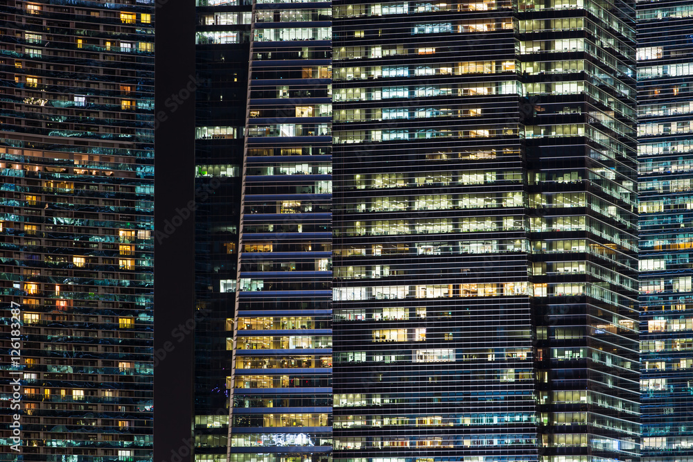 Office buildings at night in Singapore. Background with illuminated modern skyscrapers Office buildings at night in Singapore. Background with illuminated modern skyscrapers