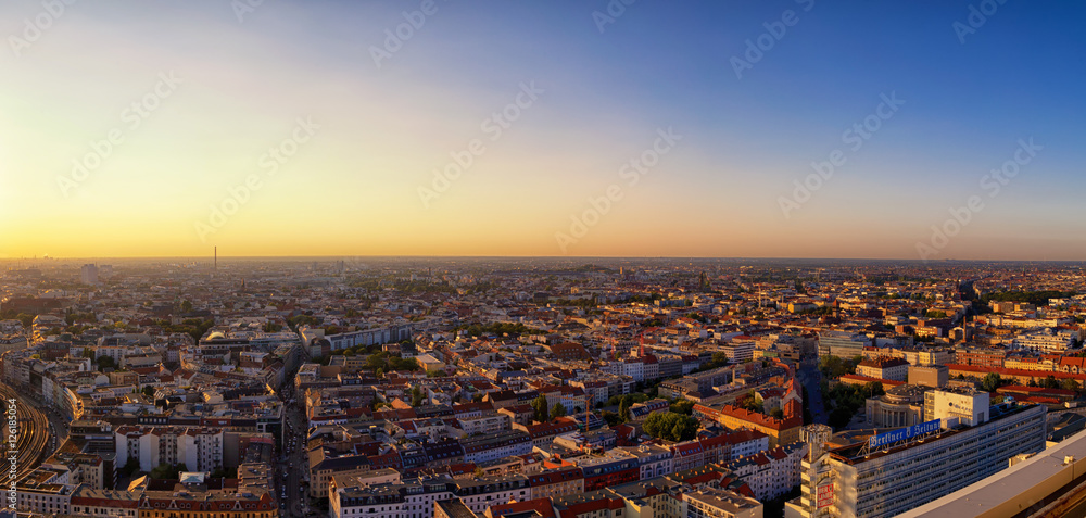 Berlin. Germany - September 2016: Beautiful panoramic aerial view over northern Berlin with romantic colorful sunset and Tegel Airport in background.