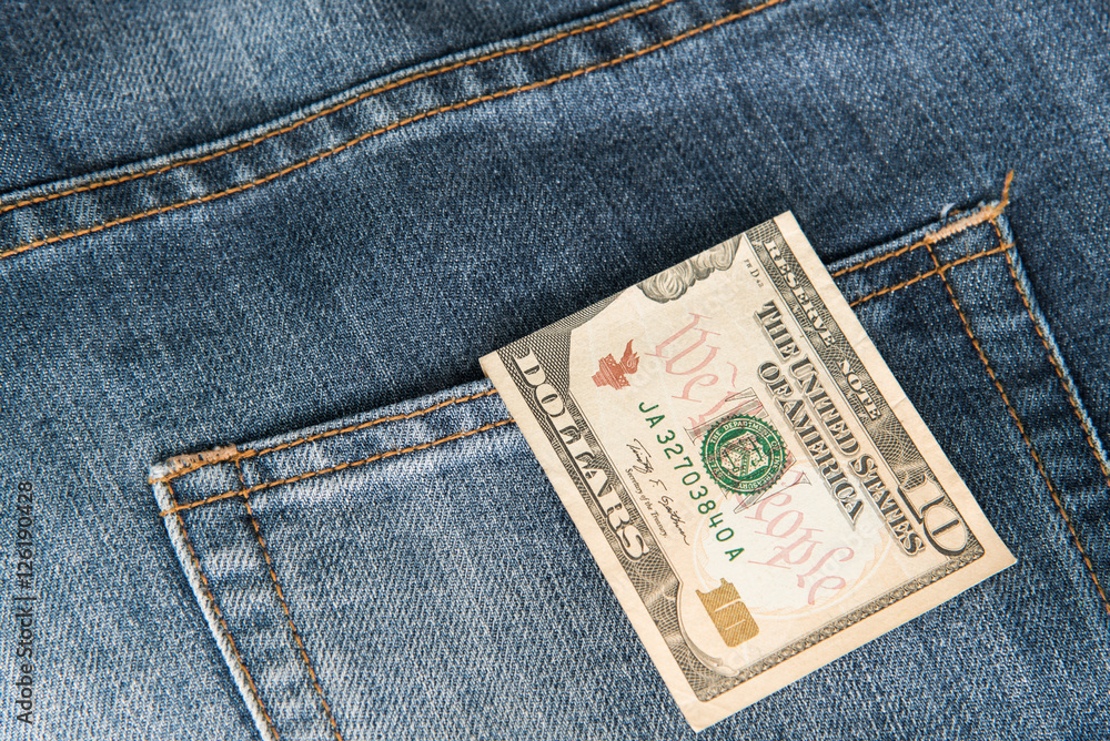 Ten American dollars bill sticking out of the blue jeans pocket,Pocket in old jeans jacket with ten US dollar,Business concept exchange Ten American dollars bill sticking out of the blue jeans pocket,Pocket in old jeans jacket with ten US dollar,Business concept exchange