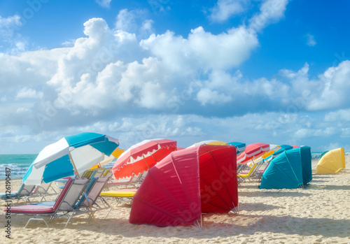 Colorful Beach umbrellas/parasols and cabanas near ocean