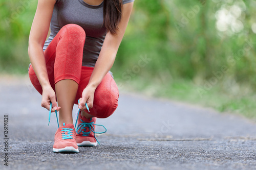 Fotografija Running shoes - closeup of woman tying shoe laces