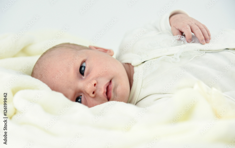 baby lying on a bed with towel baby lying on a bed with towel