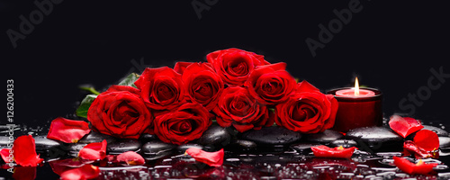 Lying down branch red rose with candle and therapy stones 