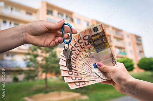 Real estate agent giving house keys to a new property owner