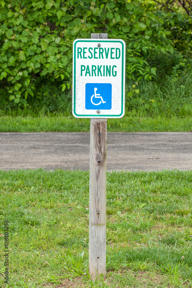 The sign of disabled parking on the street side, useful for supp