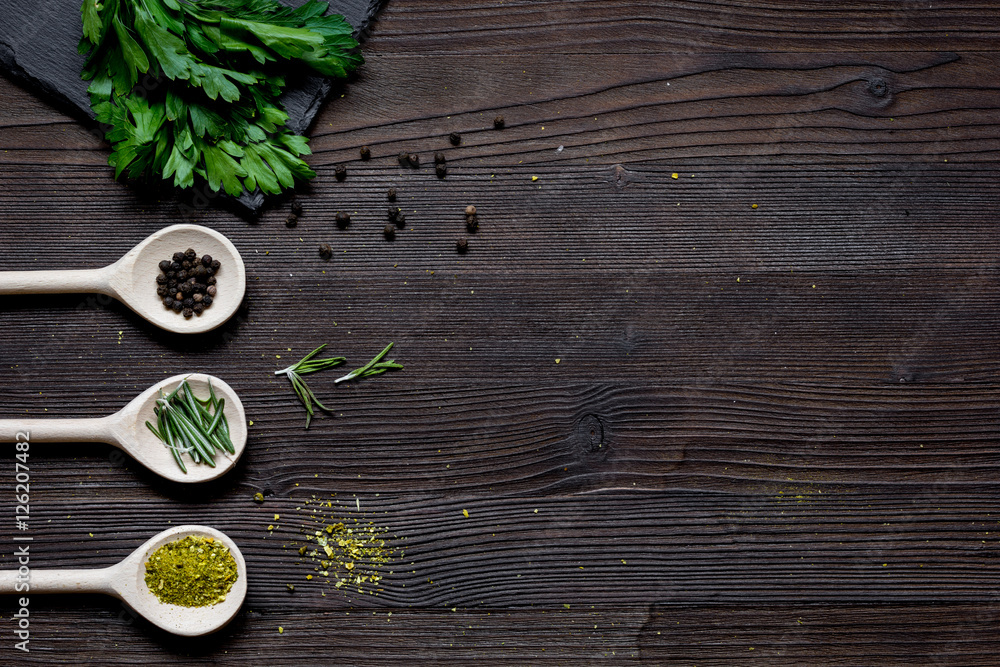 spices and fresh salad on dark wooden table top view spices and fresh salad on dark wooden table top view