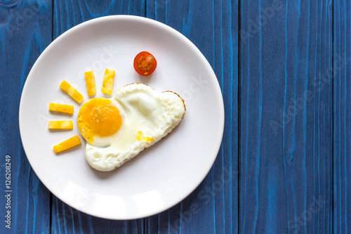 sunshine fried eggs breakfast for kid on blue background
