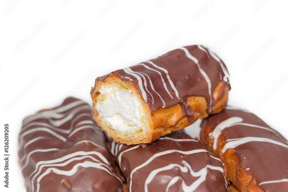 Eclairs with whipped cream and chocolate icing closeup