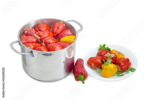 Stuffed bell peppers in stainless steel saucepot and on dish