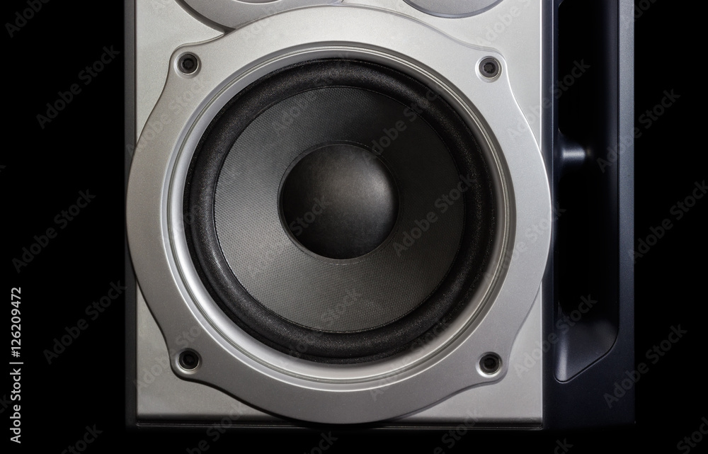 Woofer of a home loudspeaker closeup on the dark background Woofer of a home loudspeaker closeup on the dark background