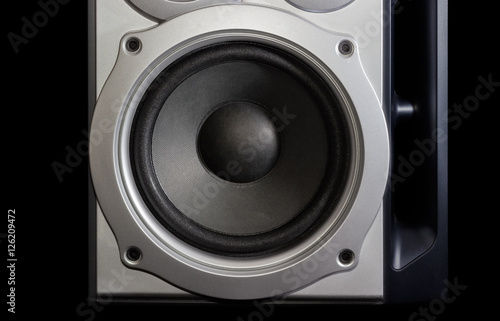 Woofer of a home loudspeaker closeup on the dark background