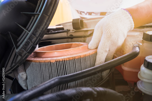 auto mechanic wearing protective work gloves holding a dirty, ai