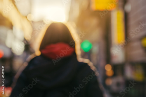 Photos Blur image of unrecognizable female person on the street