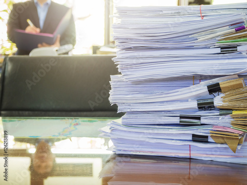 Business Concept  Pile of unfinished documents on office desk  Stack of business paper