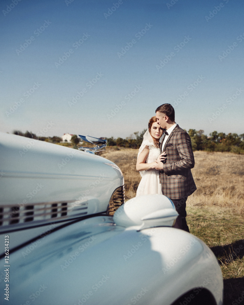 Bride and groom near vintage car Stock Photo | Adobe Stock