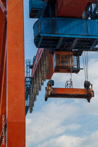 Seaport crane and container with blue cloudly sky