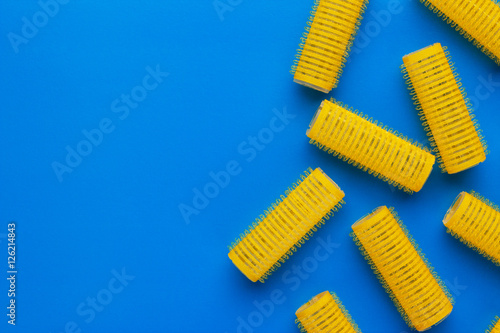 yellow hair curlers on the blue background