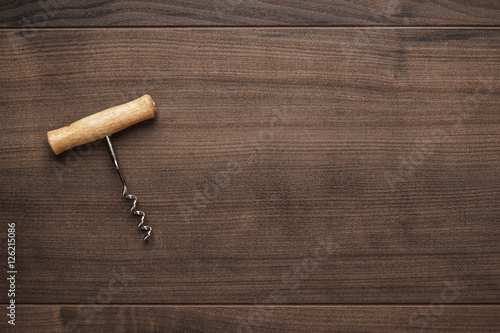 retro wooden corkscrew on the brown table photo