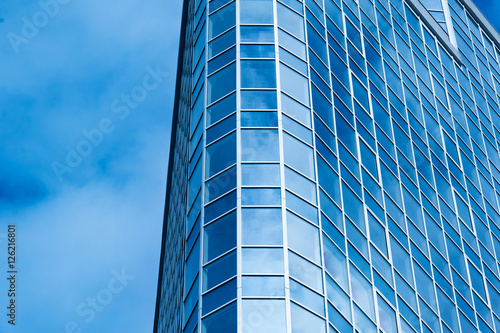 Image of modern office building against cloudy sky