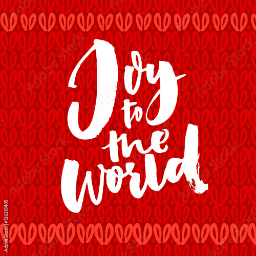 Joy to the world. Christmas greeting card with brush calligraphy. Handwriting on red knitted background