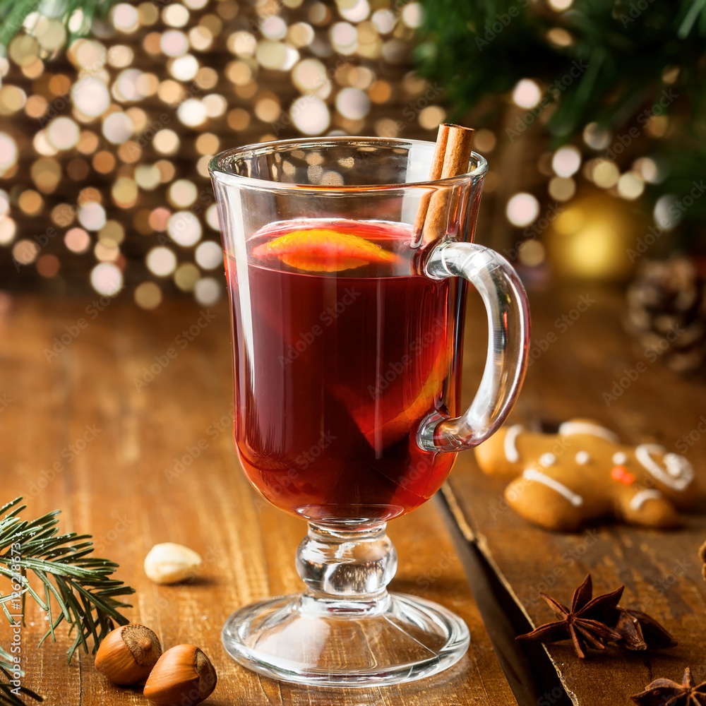 Mulled wine for Christmas Eve celebration party by Christmas tree. Hot traditional winter drink for New Year eve. Mulled wine for Christmas Eve celebration party by Christmas tree. Hot traditional winter drink for New Year eve.