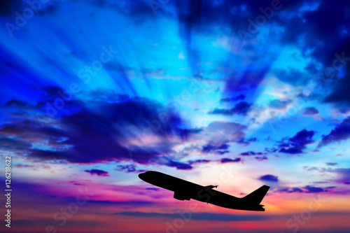 Silhouette of an airplane at sunset. © Bluesky60