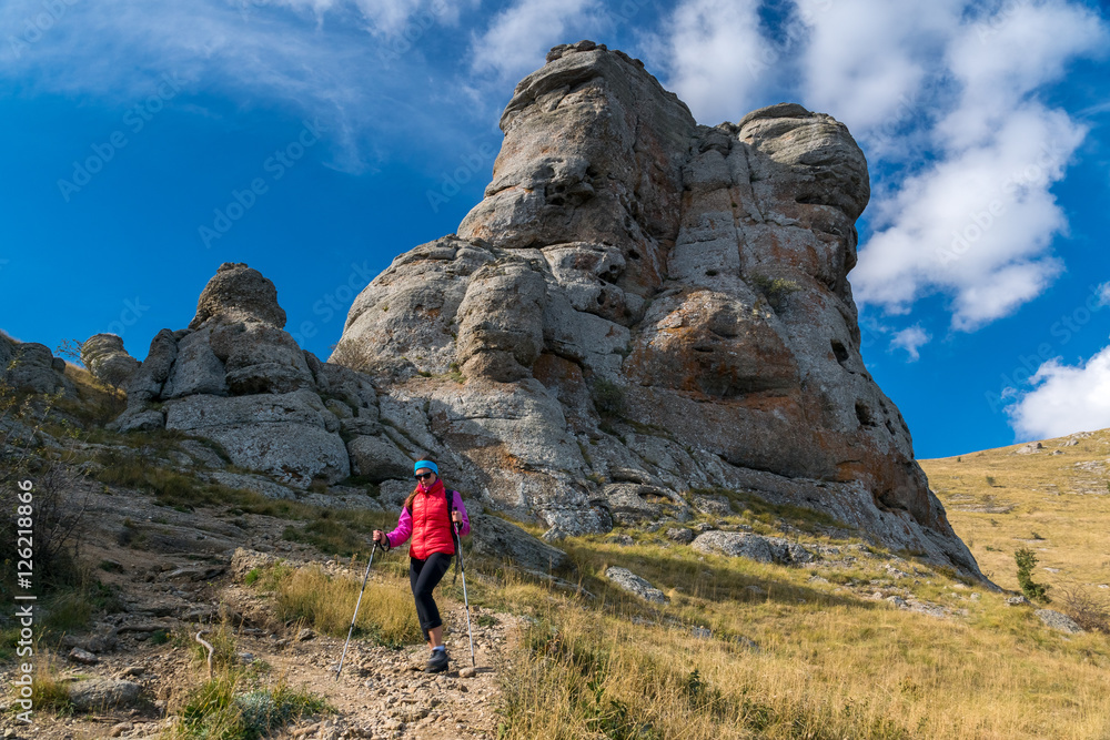 Girl tourist goes on mountainside of Demerdzhi Girl tourist goes on mountainside of Demerdzhi