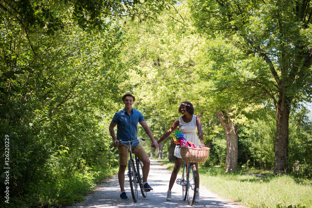 Young couple having joyful bike ride in nature Young couple having joyful bike ride in nature