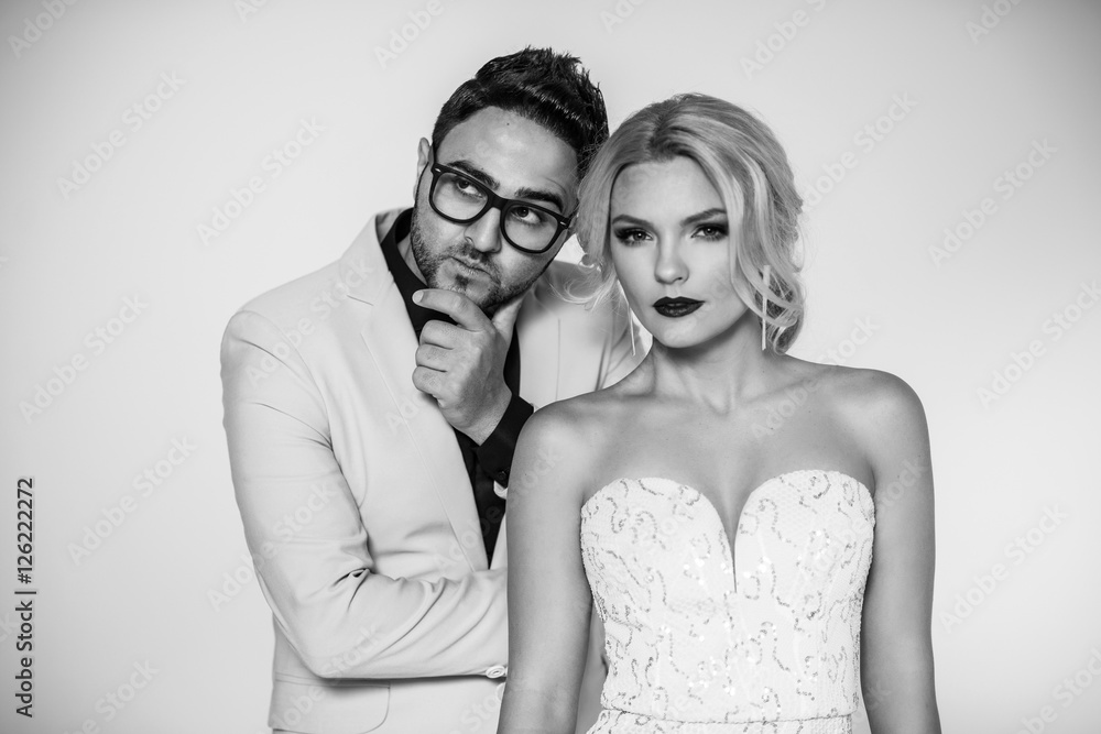 young fashion couple on a white background in studio