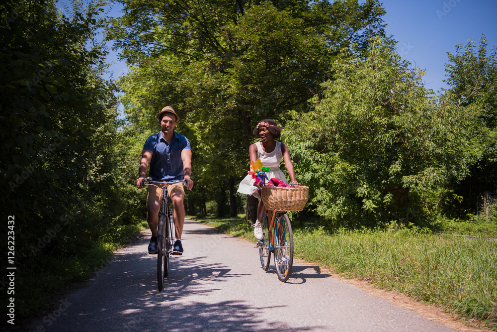 Young couple having joyful bike ride in nature Young couple having joyful bike ride in nature