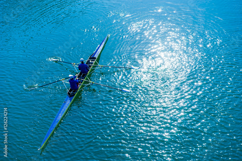 Water sports image, people rowing in canoe on river