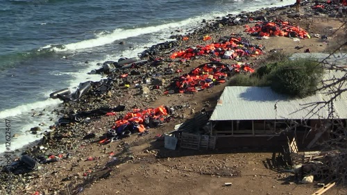 LESVOS, GREECE - NOV 2, 2015: Abandoned by the refugees belongings and life jackets on the shore.