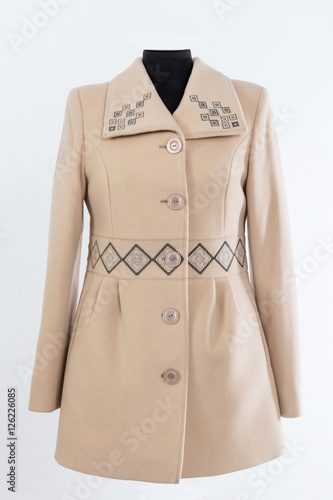 Cream - colored coat for women with details on white background