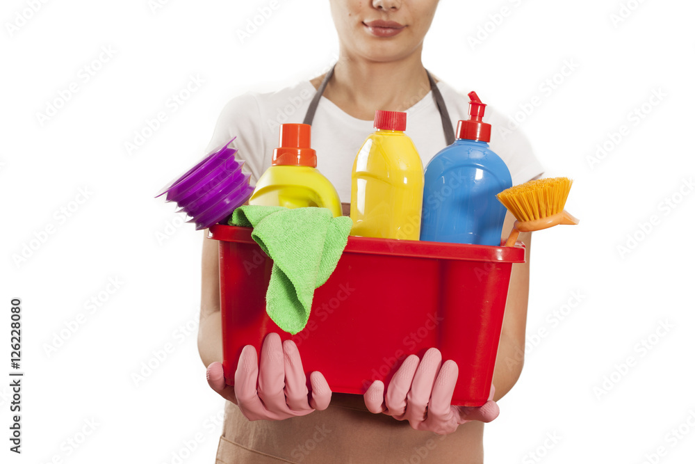 Young woman with cleaning supplies on white background Young woman with cleaning supplies on white background