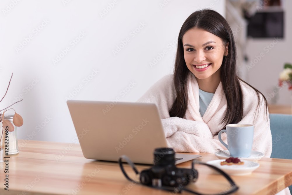 Joyful beautiful woman using laptop in a cafe. Joyful beautiful woman using laptop in a cafe.