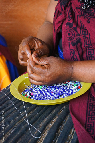 African woman making souvenirs for sell at Lesedi Cultural Villa