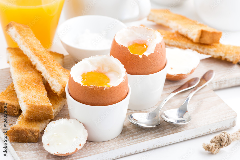boiled eggs and toasts on a wooden board boiled eggs and toasts on a wooden board