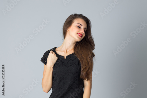 girl in black dress posing in studio