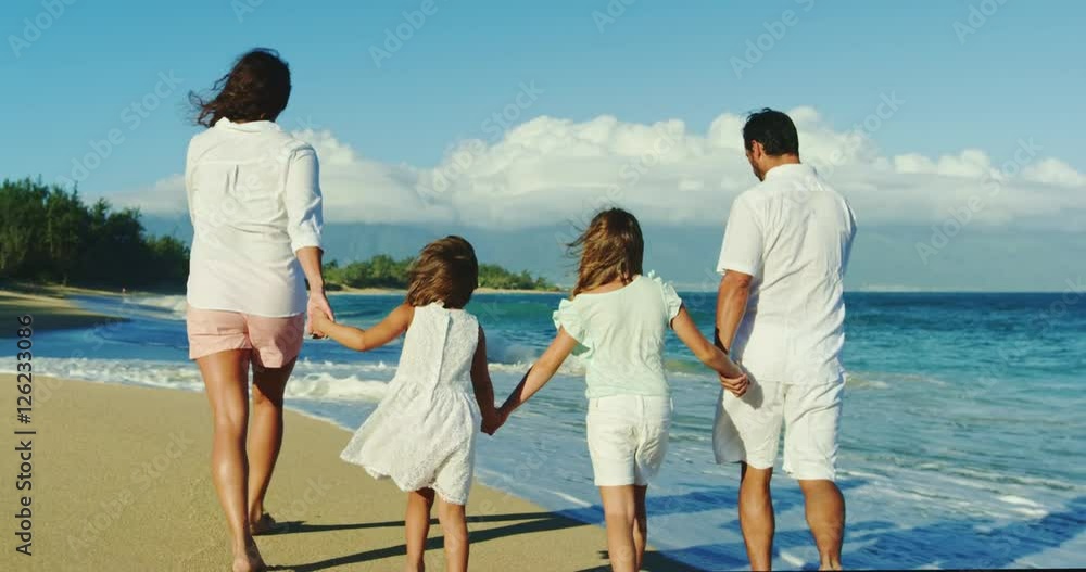 Happy family walking down the beach on vacation Happy family walking down the beach on vacation