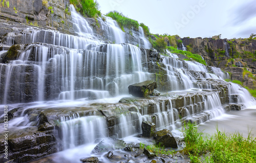 Pongour waterfall on summer days with many storied stone structure water flowing in the great stone steps. First waterfall in Lam Dong  Vietnam