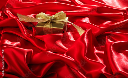 Gift box on a red satin background