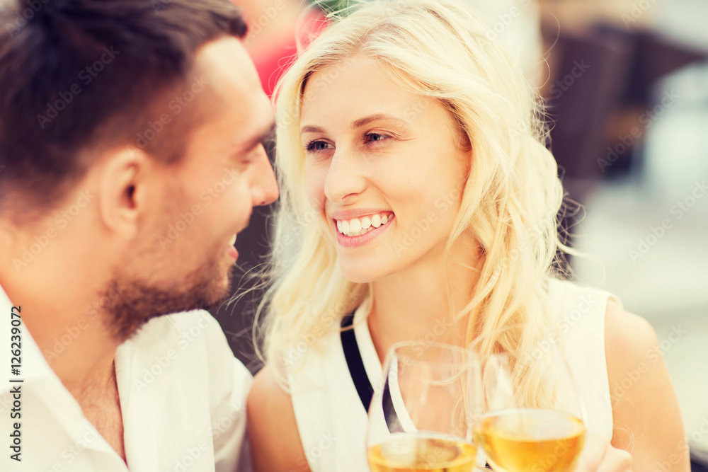 happy couple clinking glasses at restaurant lounge happy couple clinking glasses at restaurant lounge