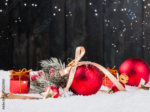 Christmas background with decorations, red celebration balls on wooden board