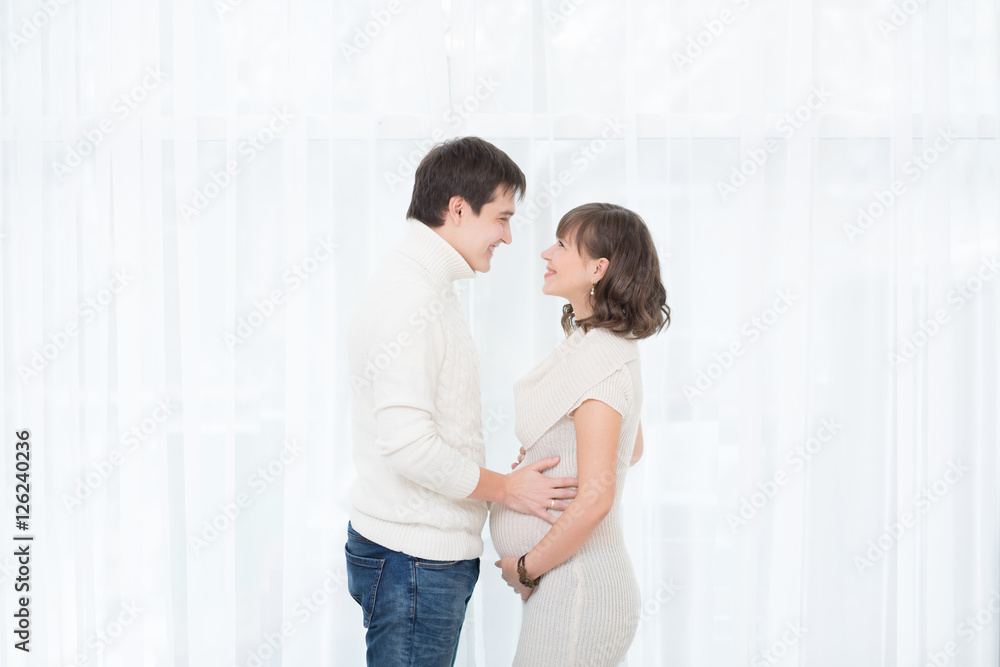 Portrait of young happy couple expecting a baby. Portrait of young happy couple expecting a baby.