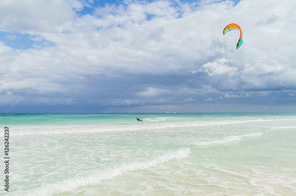 Kitesurfing in the beautiful sea. Kitesurfer in action on clear blue tropical water, Mexico Kitesurfing in the beautiful sea. Kitesurfer in action on clear blue tropical water, Mexico