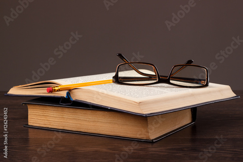 Education's equipment: books, pencil, apple and glasses